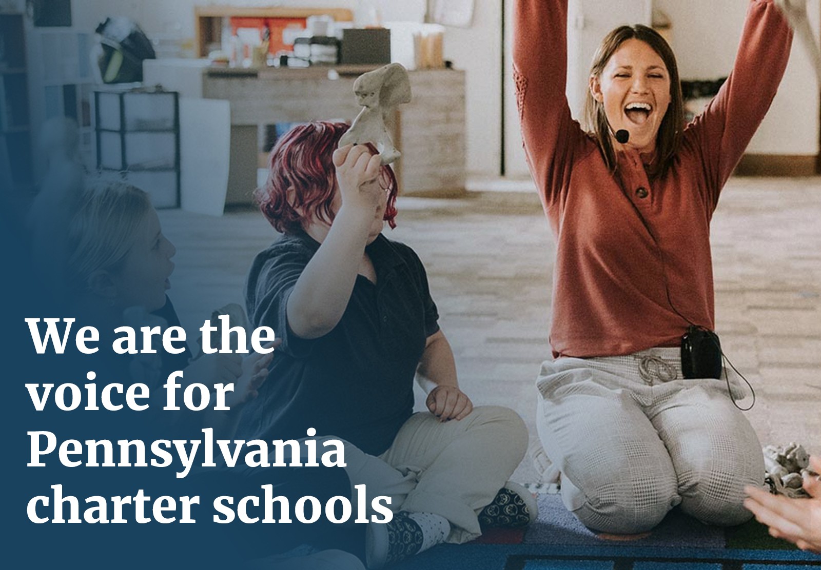 Woman with mid-length brown hair smiling with her hands above her head, large white text reads, "We are the voice for Pennsylvania charter schools"