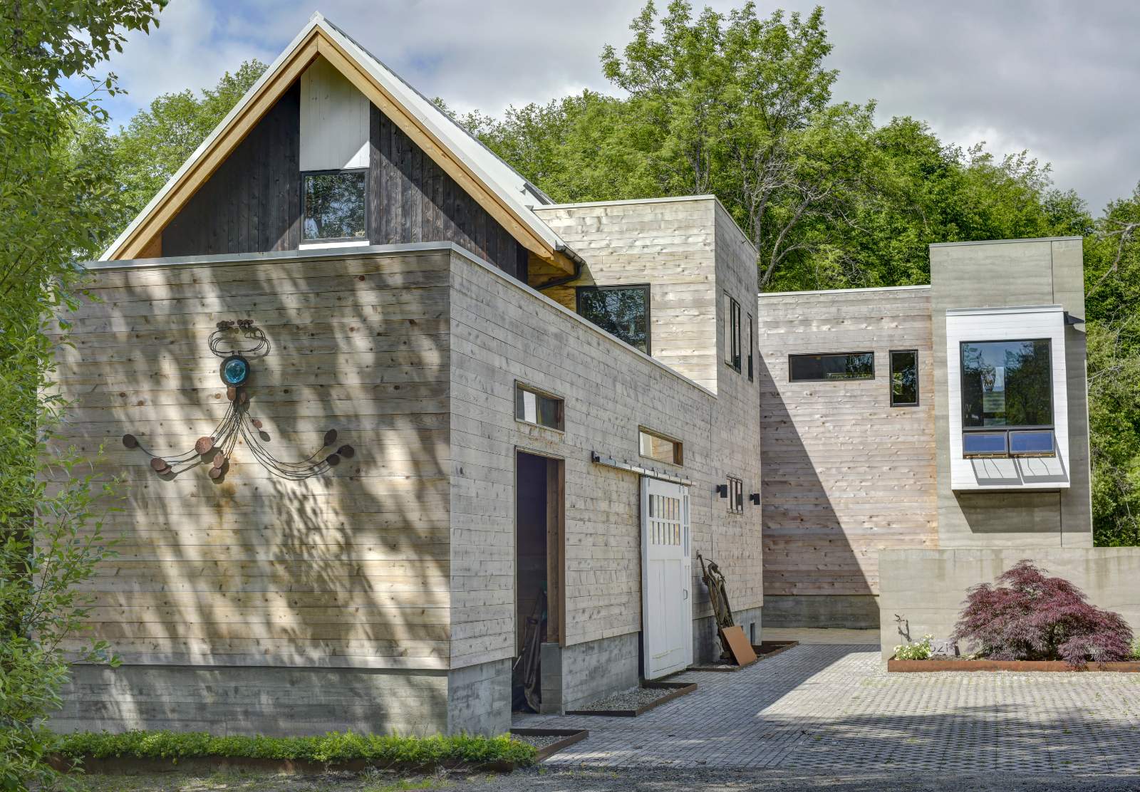 Exterior of a modern house with light grey wooden siding